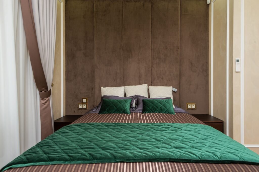 Luxury hotel style bed with layered pillows and duvet