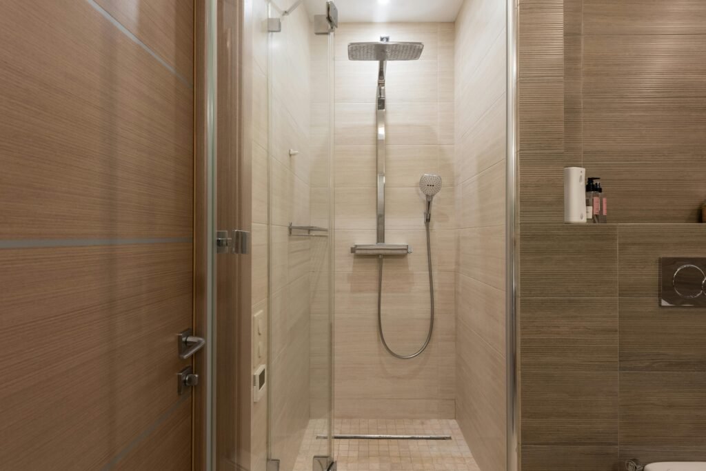 10 Bathroom Remodel Ideas on a Budget That Look Expensive Modern walk-in shower with glass doors and clean tile design