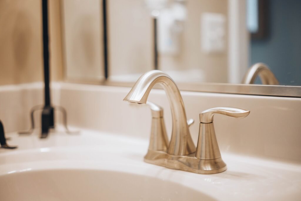 10 Bathroom Remodel Ideas on a Budget That Look Expensive Modern matte black bathroom faucet and gold fixtures close up