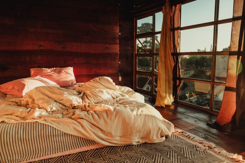 White bedding layered with soft textured blankets and pillows